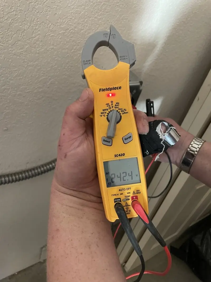 Voltage testing with clamp meter during Circuit Breaker Repair in Brandon